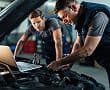 Mechanic working on a car in an auto shop